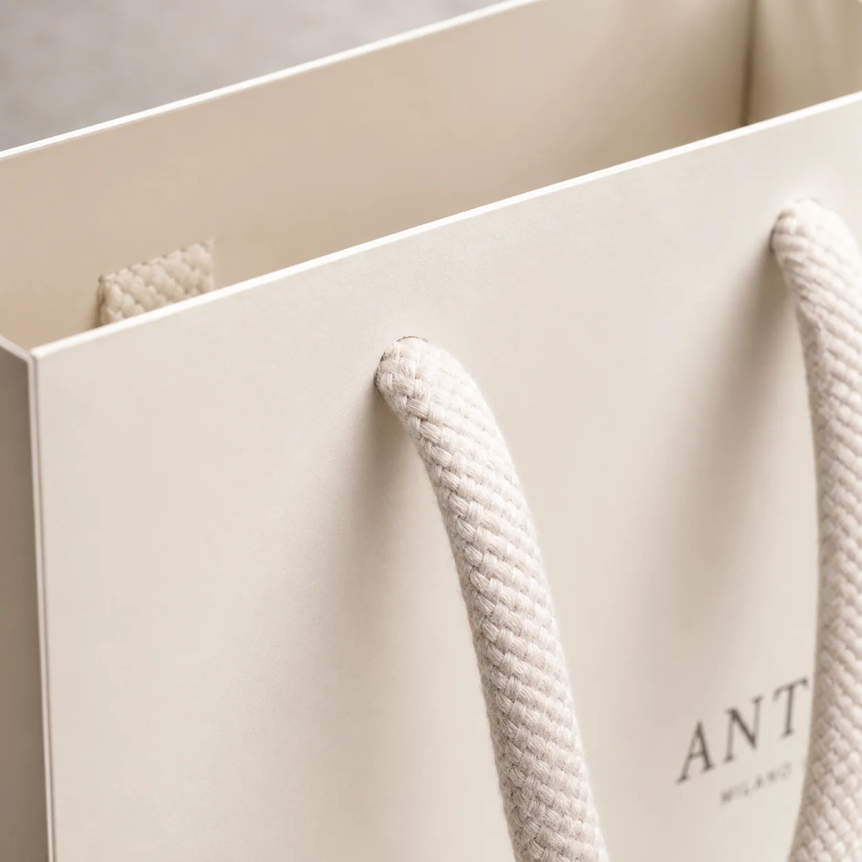 Cotton rope handle on apparel packaging.
