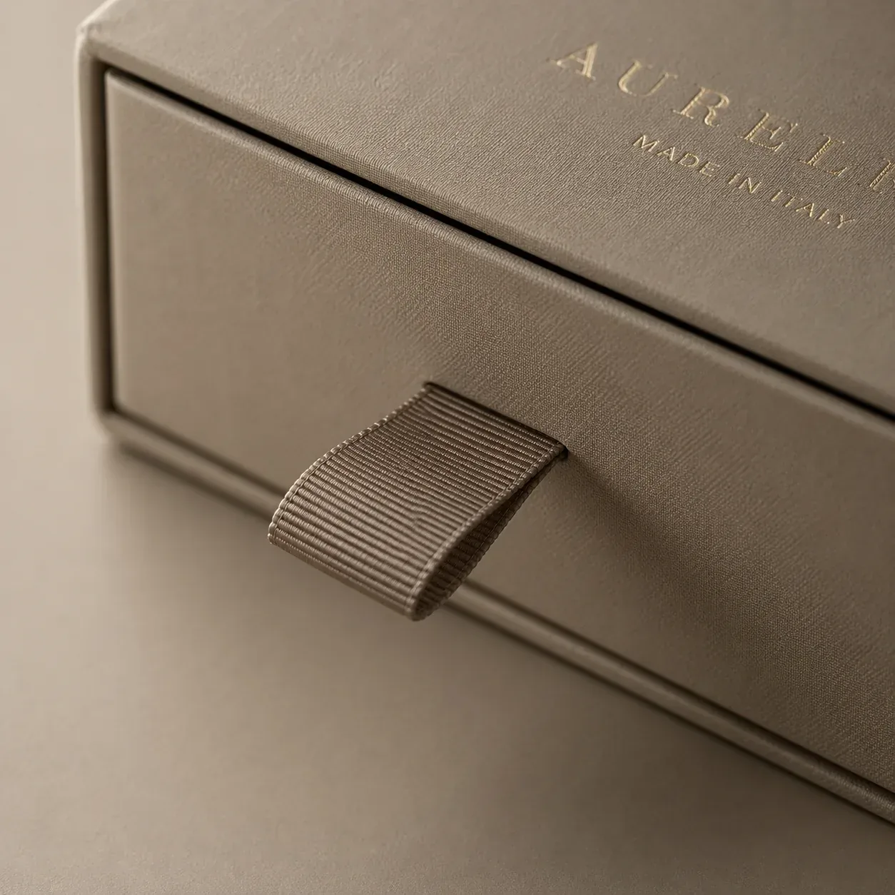 Ribbon pull tab on apparel packaging.