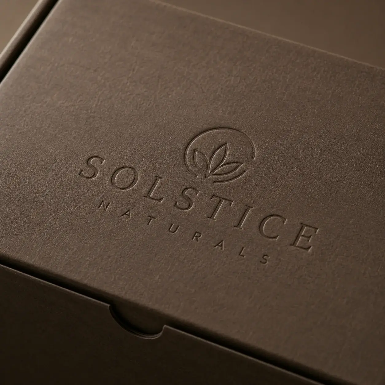 Debossed detail on e-commerce packaging.